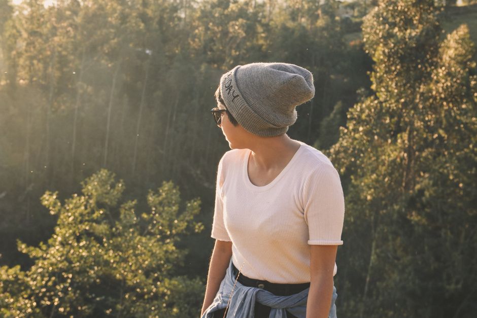 A woman enjoys a sunny hike in the scenic landscapes of Cajamarca, Peru.