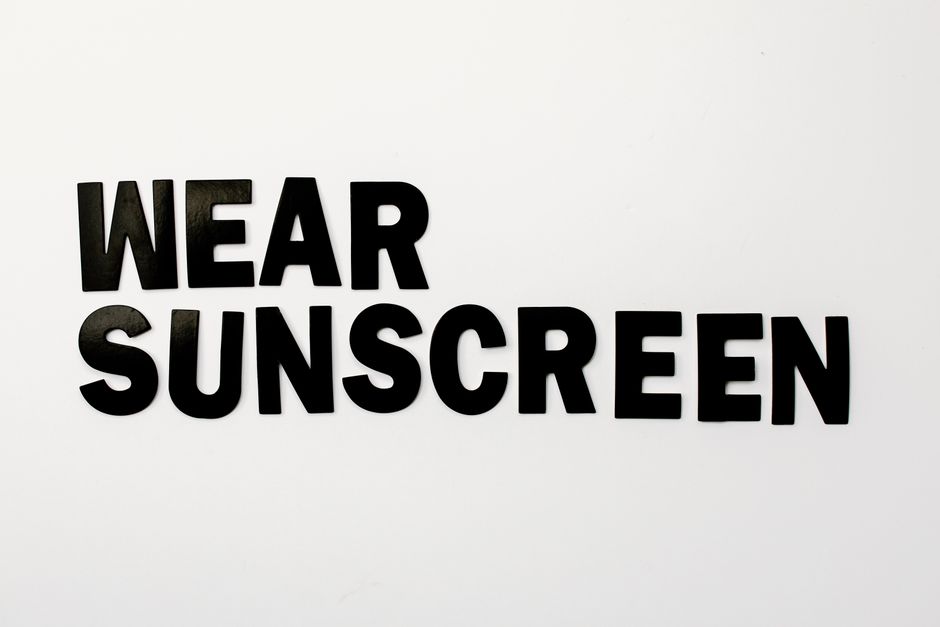 Bold lettering encouraging sunscreen use for skin protection.